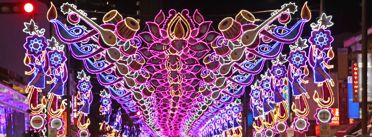Diwali street decorations with lights: sitars, drums, dancers, and lotus flower patterns.